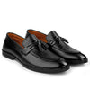 Pair of black leather loafers with tassels on a white background